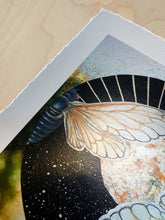 Load image into Gallery viewer, Photo shows corner of piece and decked edge. Two cicadas painted within a circle shape. Cicadas are bisected down center and each is facing the opposite direction. Black background with gold paint showing sunburst on one half and stars on the second half. Gold background that reflects the mirror used the original artwork. 8x8&quot; reproduction giclée print of Sun | Moon Cicada with a 1.25&quot; deckled edge border
