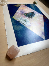 Load image into Gallery viewer, Spicebush swallowtail on scabious with pink/purple/yellow hand dyed diamond backdrop set on blue mirrored glass that reflects the original glass on artwork. 12x8" reproduction giclée print of Spicebush Swallowtail + Scabiosa with a 1.25" deckled edge border. Photo shows metallic shine at an angle, close up.