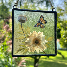 Load image into Gallery viewer, Monarch butterfly painted in gouache on paper with pressed Japanese anemone with textured clear glass backing Square shaped artwork with gold hanging chain.
