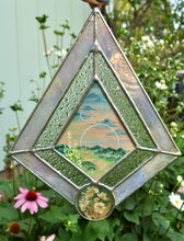 Load image into Gallery viewer, Gouache landscape set between glass with pressed wildflowers. Iridescent pink and textured clear glass border.
