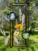 Load image into Gallery viewer, Wildflowers and yellow poppy encased in glass with yellow glass borders segmented by two light blue moth circles. Rectangle shape with brass hanging chain at top. Center glass is clear.
