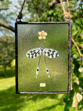 Load image into Gallery viewer, Painted blue spoon-winged antlion  in gouache on paper with pressed plum tree flower and “111”(intuition) cut from vintage textbook with clear textured glass backing. Vertical rectangle shaped artwork with twine hanging.
