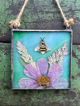 Load image into Gallery viewer, Alternate view - Honeybee painted in gouache on paper with wildflower grasses and  purple/pink cosmos flower with blue/green glass backing. Square shape with twine hanging.
