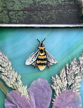 Load image into Gallery viewer, Close up of bee - Honeybee painted in gouache on paper with wildflower grasses and  purple/pink cosmos flower with blue/green glass backing. Square shape with twine hanging.
