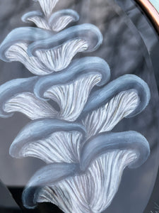 Close up of painted center of artwork. Showing blue and white-gilled oyster mushroom painted on black