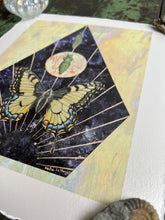 Load image into Gallery viewer, Bottom angle to show metallic shine - Swallowtail Life cycle depicts full grown swallowtail, larvae, and cocoon in vertical row. Blue/purple and metallic hand dyed background in geometrical shape (pointed top, angled sides, flat bottom). Artwork is on yellow iridescent glass to mimic original piece. 8x10&quot; reproduction giclée print of Swallowtail Life Cycle with a 1.25&quot; deckled edge border
