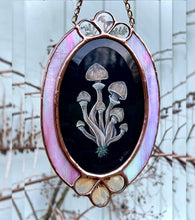 Load image into Gallery viewer, Full view of artwork - oval shape with three teardrop shaped glass pressed flower and mushroom inclusions at top and bottom of piece. Gouache and holographic powder on paper with pressed wild mushroom, fern, and cosmos flowers set between pink rainbow iridescent glass
